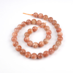 Güneştaşı doğal taş dizi 10 mm – altın ışıltılı turuncu tonlarıyla canlılık, özgüven ve pozitif enerji sağlayan toptan doğal taş dizi