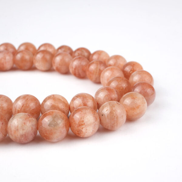 Güneş Taşı doğal taş dizi 7 mm – altın ışıltılı turuncu tonlarıyla canlılık, mutluluk ve özgüven sağlayan toptan doğal taş dizi