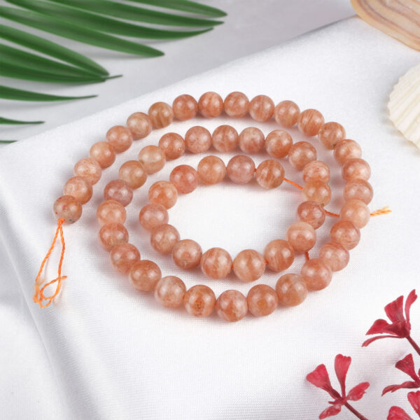 Güneş Taşı doğal taş dizi 7 mm – altın ışıltılı turuncu tonlarıyla canlılık, mutluluk ve özgüven sağlayan toptan doğal taş dizi