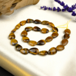 Kaplangözü doğal taş dizi – altın ve kahverengi tonlarının enerjik parıltısıyla cesaret, özgüven ve koruma sağlayan güçlü bir toptan doğal taş dizi.