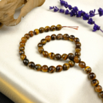 Kesimli Kaplangözü doğal taş dizi 8mm – sarı ve kahverengi tonların birleşimiyle odaklanma, cesaret ve içsel güç sağlayan parlak yüzeyli toptan doğal taş dizi