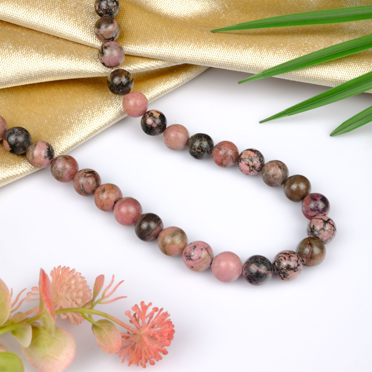 Rodonit toptan doğal taş dizi 12mm – pembe ve siyah tonlarıyla sevgi, şefkat ve duygusal denge enerjisi yayan doğal taş modeli.