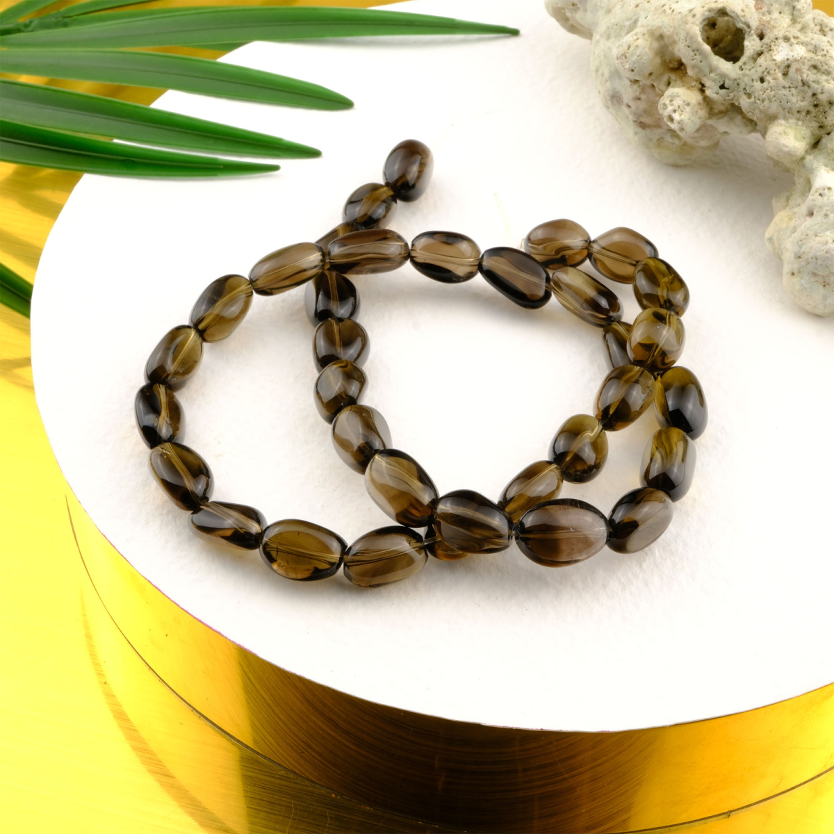 Tamburlu kesim Dumanlı Kuvars taşı, toprak tonlarında yumuşak yüzeyli formuyla koruma, denge ve arınma enerjisini sunan toptan doğal taş dizi.