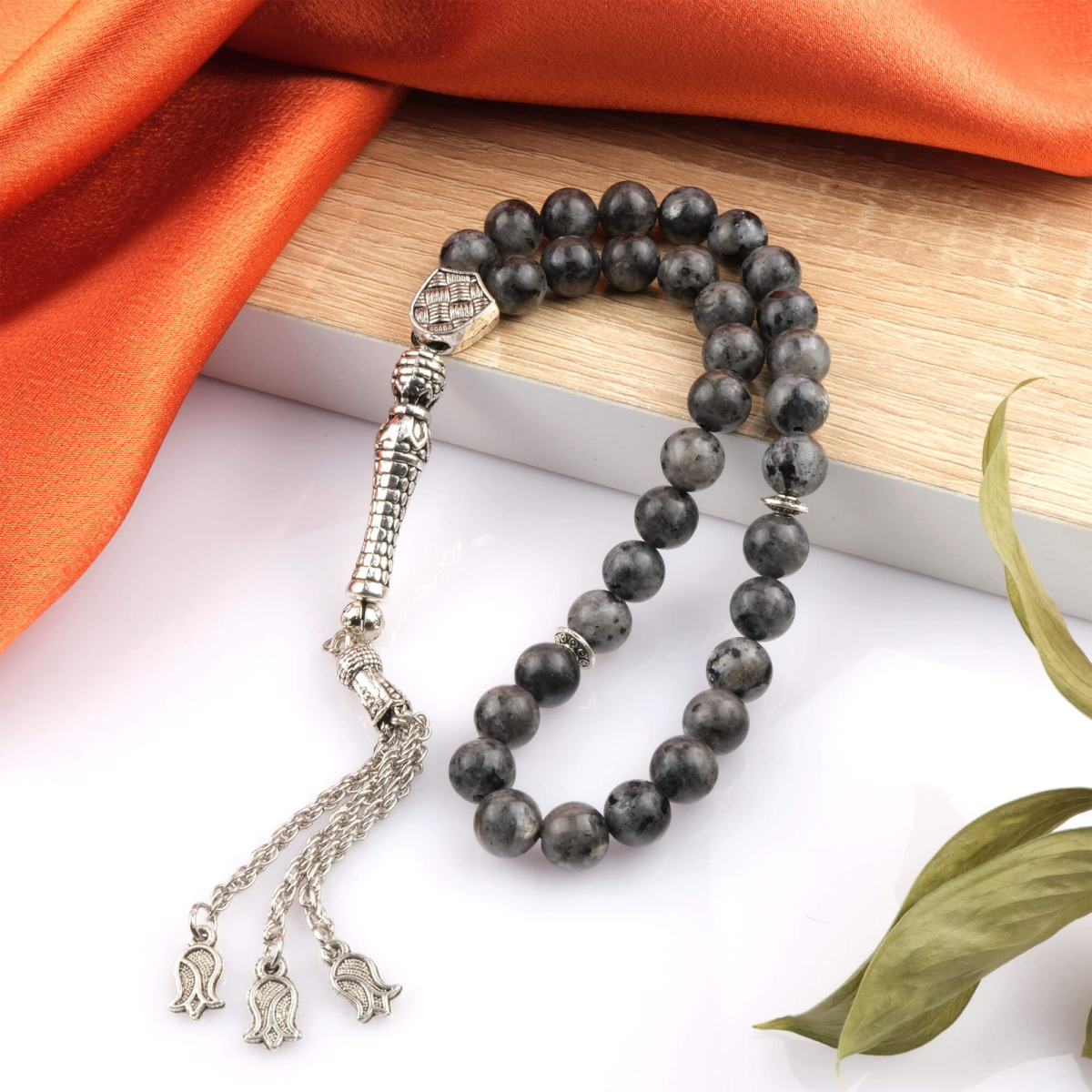 Toptan doğal taş spektrolit tesbih, koyu zemin üzerinde mavi ve yeşil ışık yansımalarıyla farkındalık ve koruyucu enerji sunan, manevi kullanım ve koleksiyon için ideal doğal taş tesbih