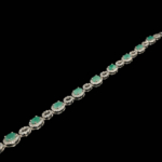 925 sterling silver women's bracelet designed with oval cut original emerald natural stones and sparkling details.