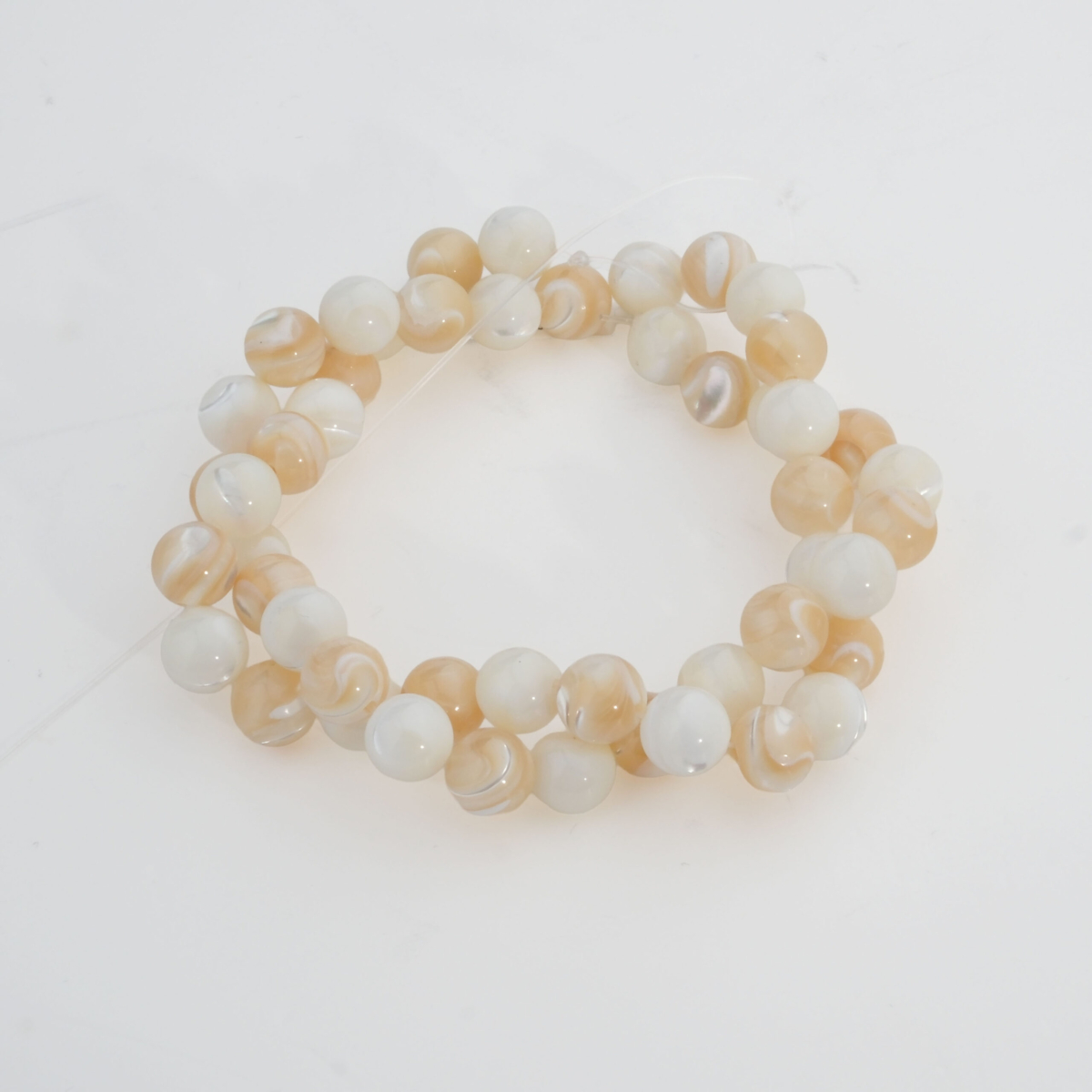 8mm mother of pearl natural stone bead strand in white and brown tones.