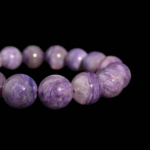 A luxury flexible natural stone bracelet made of 13-14mm large round smooth purple veined 6A+ quality charoite beads.