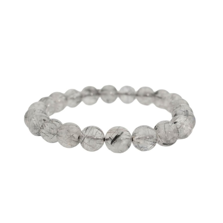 A luxury flexible natural stone bracelet made of 8-9mm round smooth clear quartz beads with sharp black rutilated inclusions in 6A+ quality.