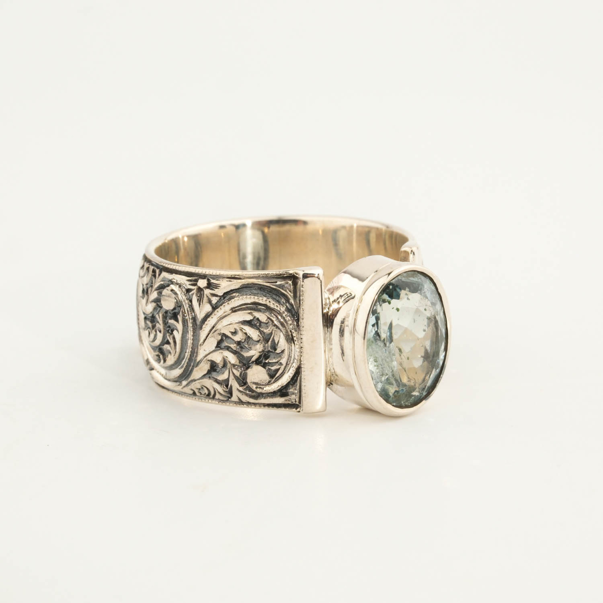 925 sterling silver mens ring featuring an oval facet cut original aquamarine natural stone and masterfully engraved surroundings.