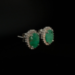 A luxury designer earrings made of original oval faceted emerald gemstones set in a 925 sterling silver halo with sparkling zircon accents.