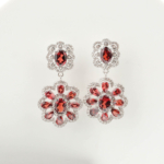 A luxury designer earrings featuring original faceted oval and teardrop red garnet gemstones set in 925 sterling silver with zircon accents.