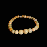 A luxury flexible natural stone bracelet made of graduated round opal beads showing vibrant play-of-color effects.