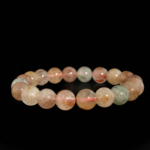 A luxury flexible natural stone bracelet made of 9-10mm round smooth clear quartz beads with multicolor rutilated inclusions.