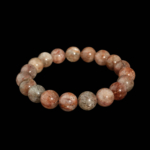 Bracciale flessibile in pietra naturale realizzato con perle rotonde e lisce di quarzo trasparente da 10-11mm con inclusioni di rutile di rame misto.