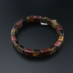 Rolex cut flexible natural stone bracelet made of original tiger's eye stones in gold, red, and blue tones.