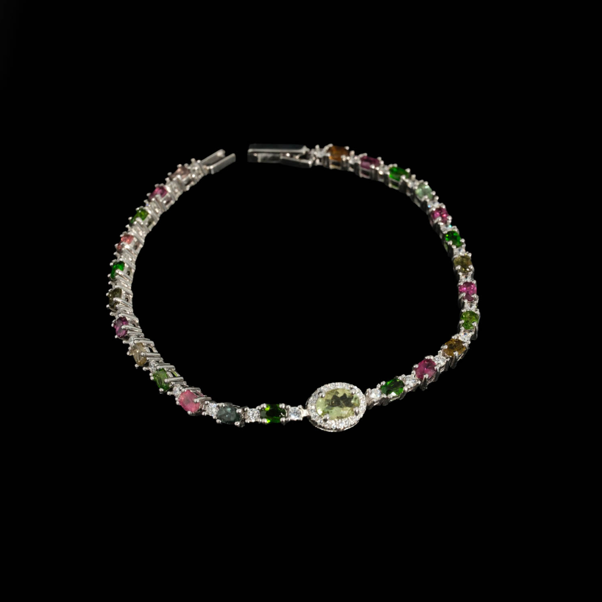 A luxury designer women's bracelet featuring original faceted cut multicolor tourmaline stones set in 925 sterling silver with a central green tourmaline focus.