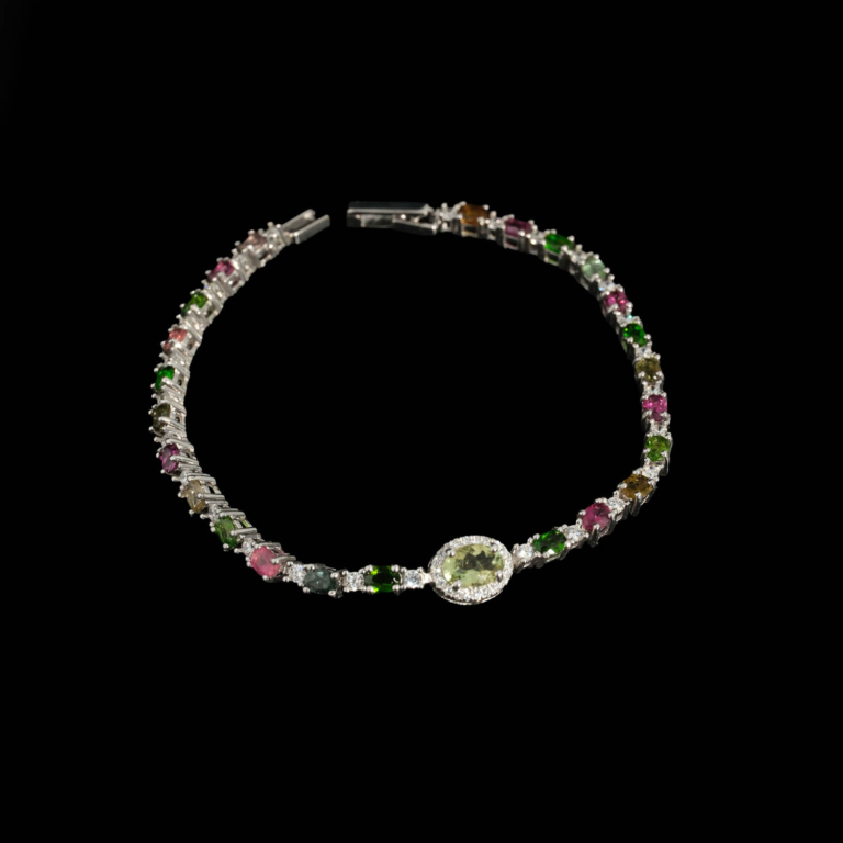 A luxury designer women's bracelet featuring original faceted cut multicolor tourmaline stones set in 925 sterling silver with a central green tourmaline focus.