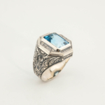 925 sterling silver mens ring featuring a rectangular facet cut original blue topaz natural stone and handcrafted engravings.
