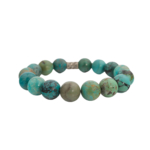 Bracelet flexible en pierre naturelle fait de grandes perles rondes de turquoise veinée avec une entretoise argentée.