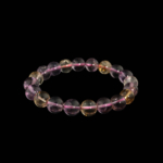 Pulsera flexible de piedra natural hecha de cuentas redondas y lisas de ametrina de 10-11mm que muestran zonas de color purpura y amarillo.