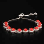 Pulsera ajustable de plata de ley 925 con 9 piedras de coral rojo rodeadas por marcos circulares de circonitas, exhibida en DSCF0676.jpg.