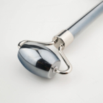 Original terahertz natural stone face roller massage tool with smooth metallic shiny heads designed for skincare and facial massage, featured in DSCF0783.jpg.