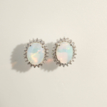 A luxury designer earrings made of original oval cabochon opal gemstones set in a 925 sterling silver halo with sparkling zircon accents.