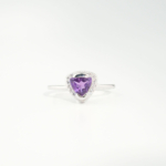 A delicate women's statement ring featuring a trillion-cut original amethyst gemstone surrounded by cubic zirconia in 925 sterling silver.