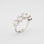 A luxury 4 carat five-stone ring featuring five certified D color VVS1 round brilliant moissanite gemstones set in 925 sterling silver with a GRA certificate.