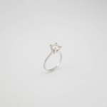 A luxury solitaire designer ring featuring a certified D color VVS1 round brilliant moissanite gemstone set in a four-prong 925 sterling silver band with a GRA certificate.