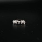 A luxury 1.5 carat five-stone ring featuring five certified D color VVS1 round brilliant moissanite gemstones set in 925 sterling silver with a GRA certificate.