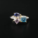 Anillo de diseño de lujo para mujer en plata de ley 925, adornado con gemas naturales de topacio azul, zafiro y amatista de corte faceteado.