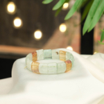 A luxury statement bracelet featuring original rolex style rectangular cut colorful fluorite gemstones with natural color bands.
