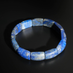 A luxury men's statement bracelet featuring original rolex style rectangular cut deep blue lapis lazuli gemstones with pyrite inclusions.