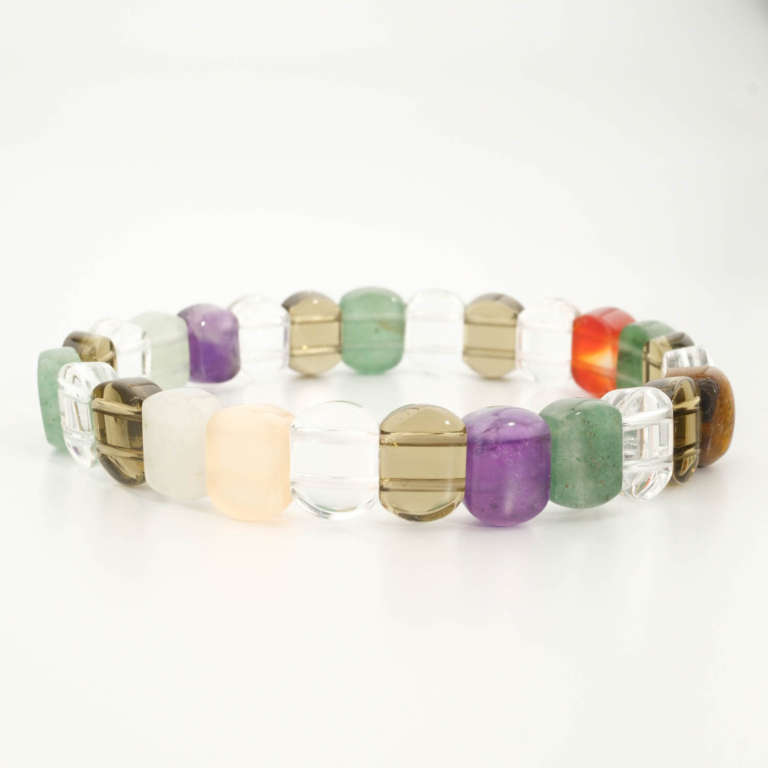 A luxury multi-gemstone chakra bracelet featuring original rolex-cut natural gemstone beads on a stretch band.