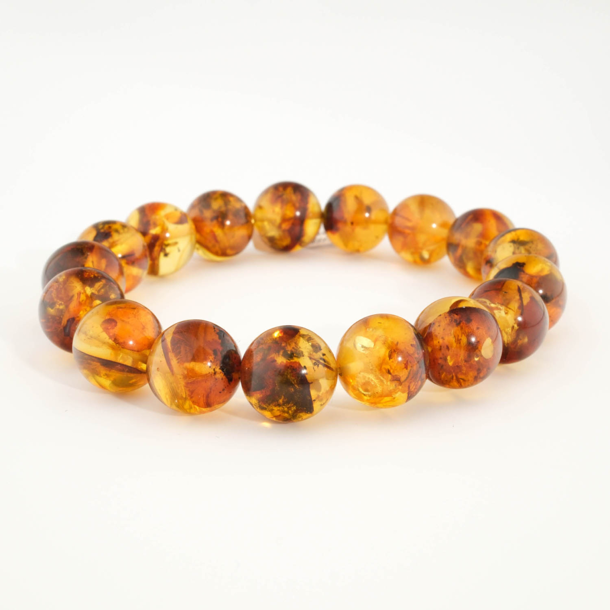 Bracciale di ambra baltica originale da 12-13mm a sfere lisce per adulto con sfumature cognac.