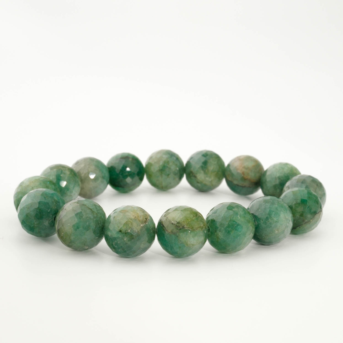 A luxury statement gemstone bracelet featuring original 12-13mm 6A+ grade faceted emerald round beads on a stretch band.