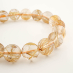 Bracelet de luxe orné de perles rondes de 10,23-10,28mm en quartz rutile doré naturel original de qualité 10A+ VIP certifié.