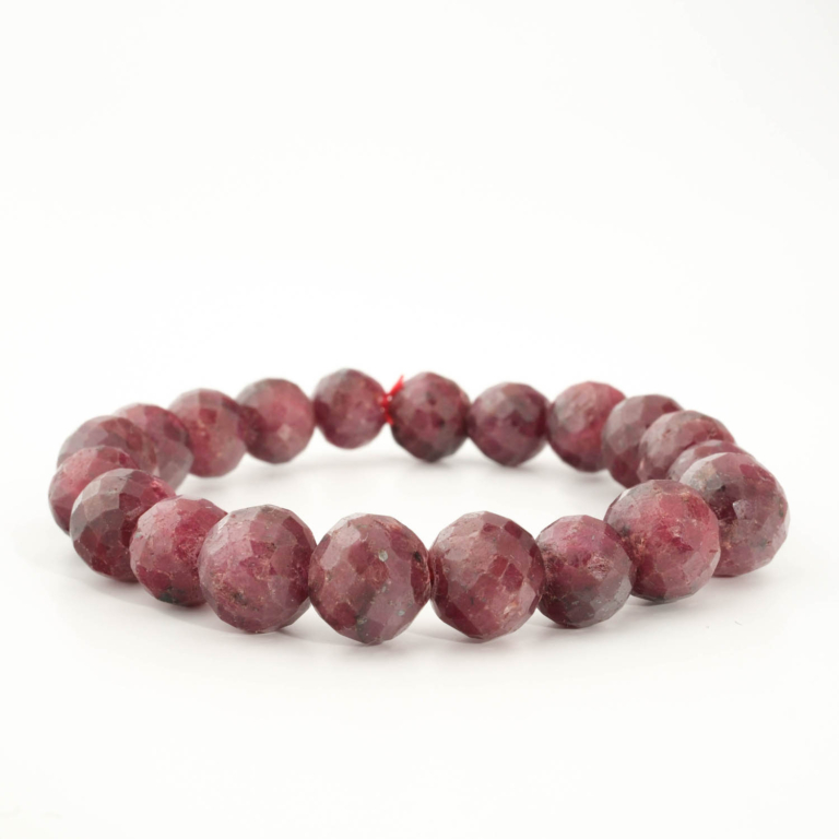 A luxury statement gemstone bracelet featuring original 10-11mm 5A+ grade faceted ruby round beads on a stretch band.