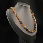 A certified original Baltic amber gemstone adult necklace (20-23g, 59-62cm) featuring smooth dark cognac amber beads.