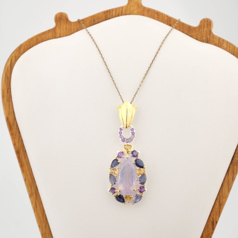 A luxury designer necklace featuring a large pear faceted lavender amethyst surrounded by sapphire and citrine gemstones in 925 sterling silver.