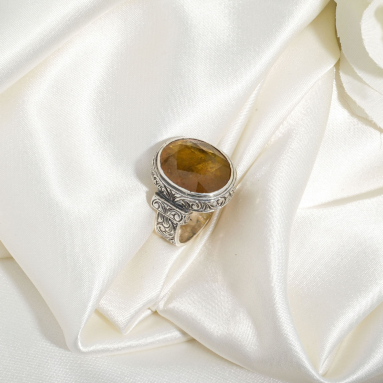 A luxury handmade statement ring featuring an original 12.45ct yellow sapphire gemstone set in 925 sterling silver with engraved details.