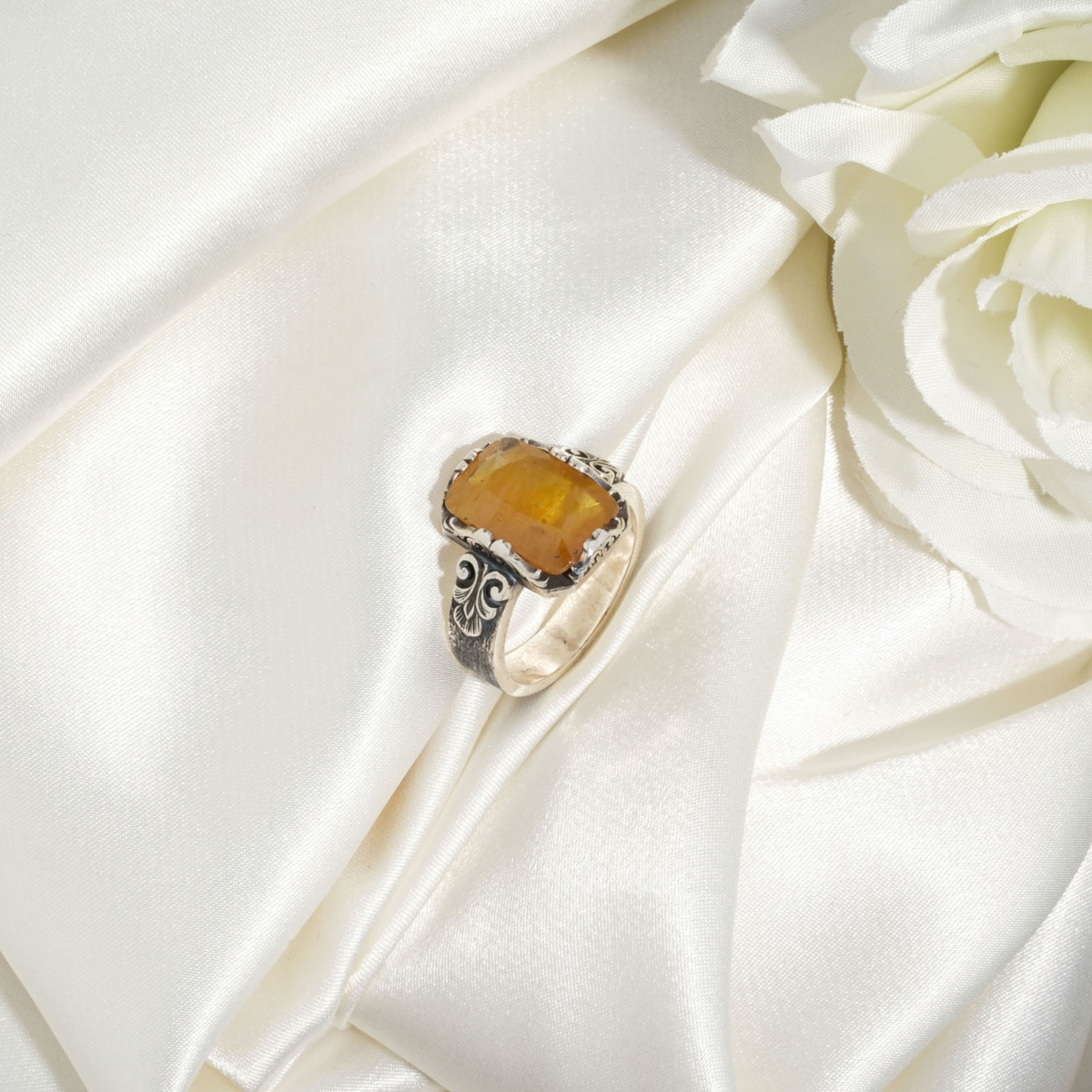 A luxury handmade statement ring featuring an original 8.25ct rectangular yellow sapphire gemstone set in 925 sterling silver with engraved details.