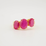 A luxury women's three-stone ring featuring original oval faceted rubies set in gold-plated 925 sterling silver.