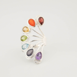 A luxury multi-gemstone statement ring featuring seven natural chakra stones set in a 925 sterling silver fan design.