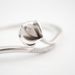 A luxury designer bangle bracelet featuring intricate enamel details and sparkling micro zircon stones in 925 sterling silver.