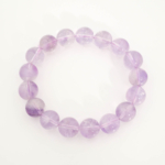 A luxury statement gemstone bracelet featuring original 12-13mm 5A+ grade lavender amethyst round beads on a stretch band.