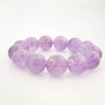 A luxury statement gemstone bracelet featuring original 18-19mm 5A+ grade lavender amethyst round beads on a stretch band.