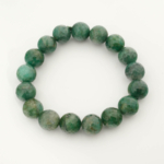 A luxury statement gemstone bracelet featuring original 11-12mm 6A+ grade faceted emerald round beads on a stretch band.