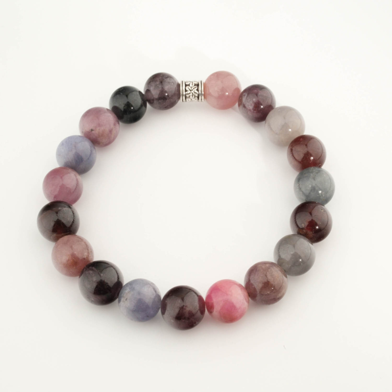 A luxury statement gemstone bracelet featuring original 10mm multi-color spinel round beads on a stretch band.